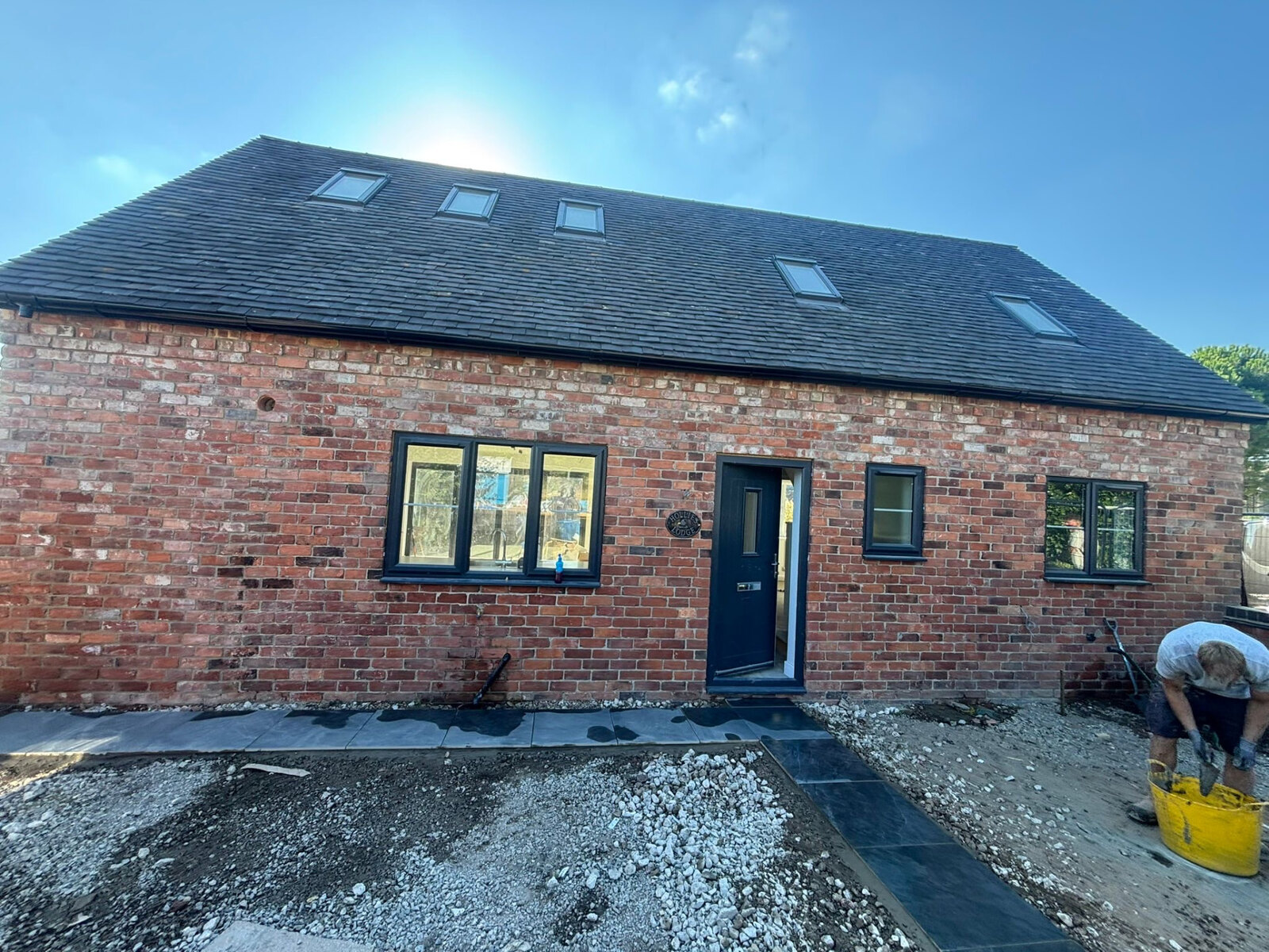 Barn style property in reclaimed red brickwork with clay tiled roof after restoration