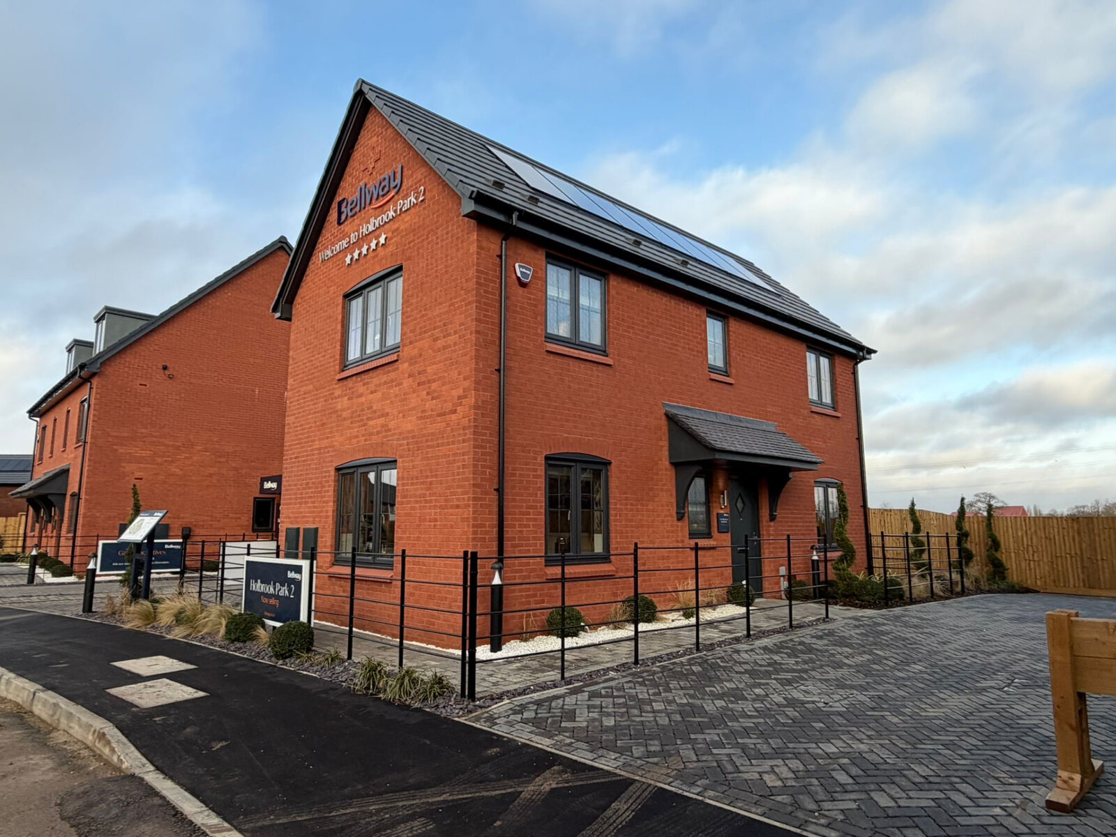 Red brick show home at Holbrook Park with feature gable and canopy porch