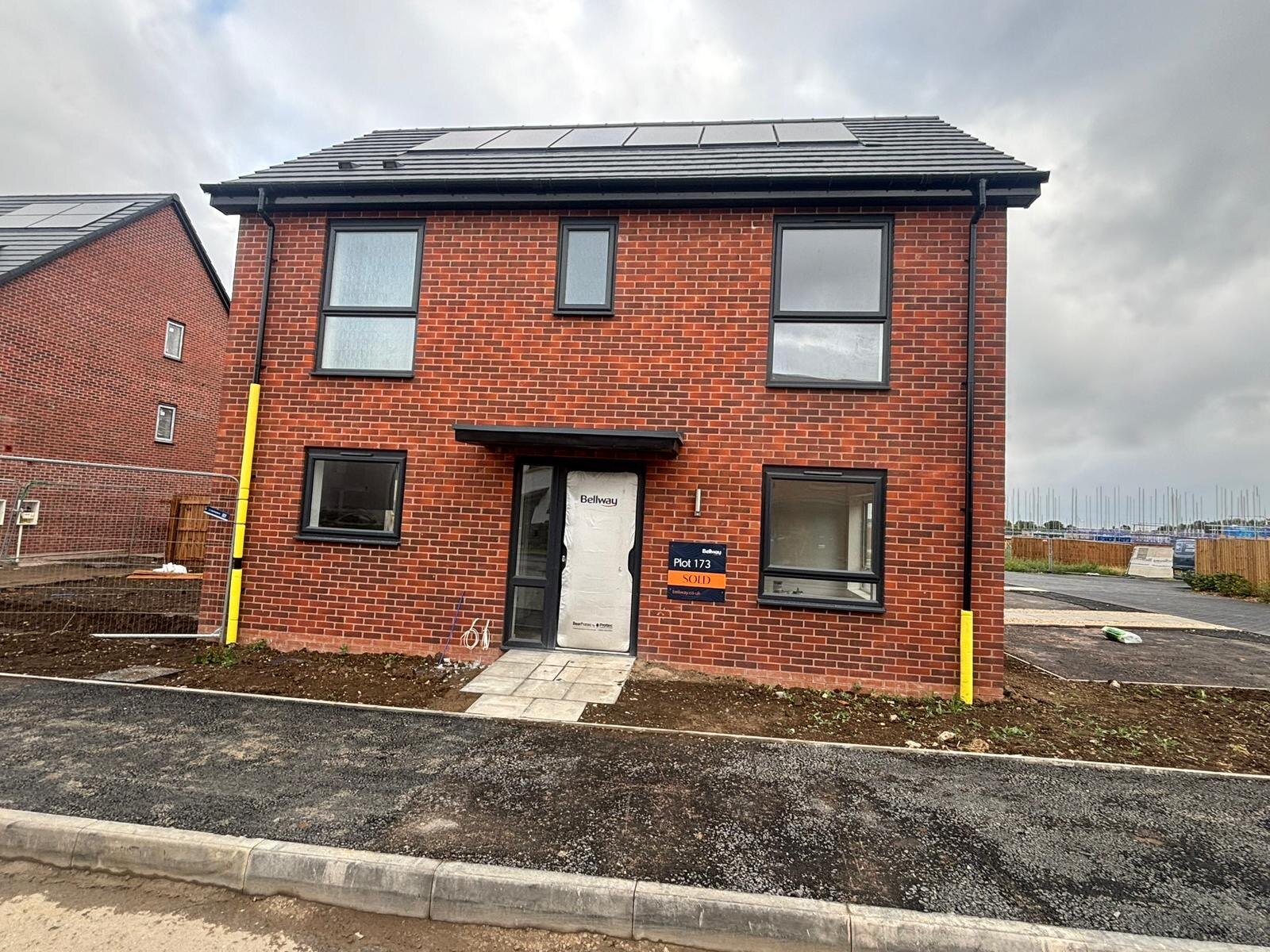 Completed red brick new build plot with solar panels on a Derbyshire development