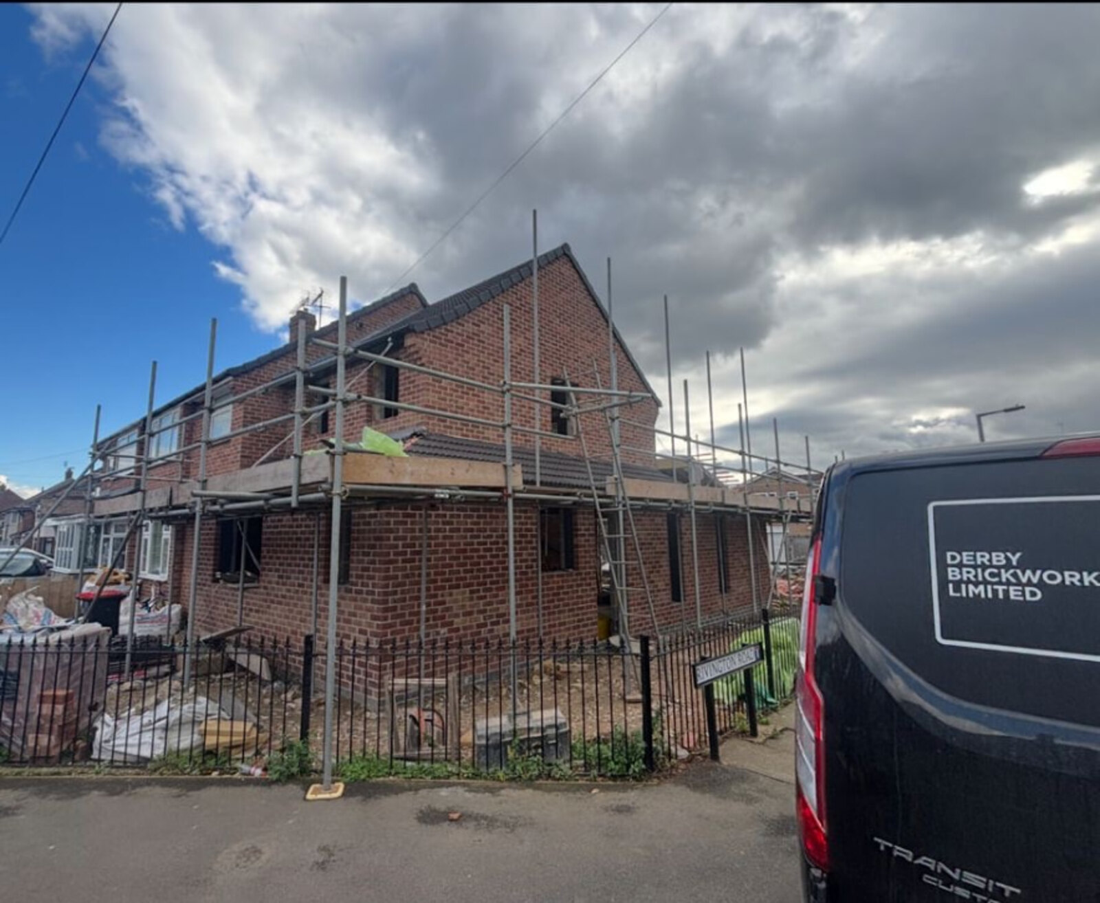 Derby Brickwork Limited van on site at a two storey extension in red brickwork