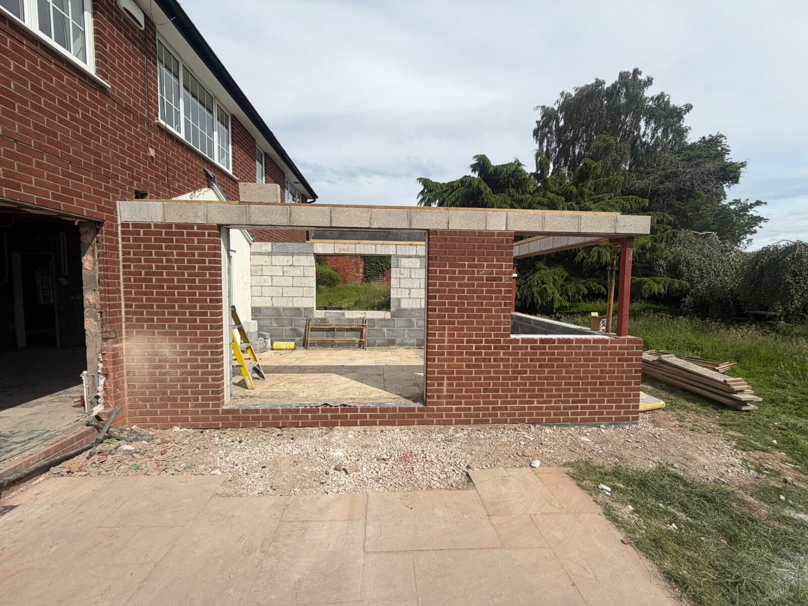 Rear extension brickwork tied into an existing red brick house with wide bifold opening