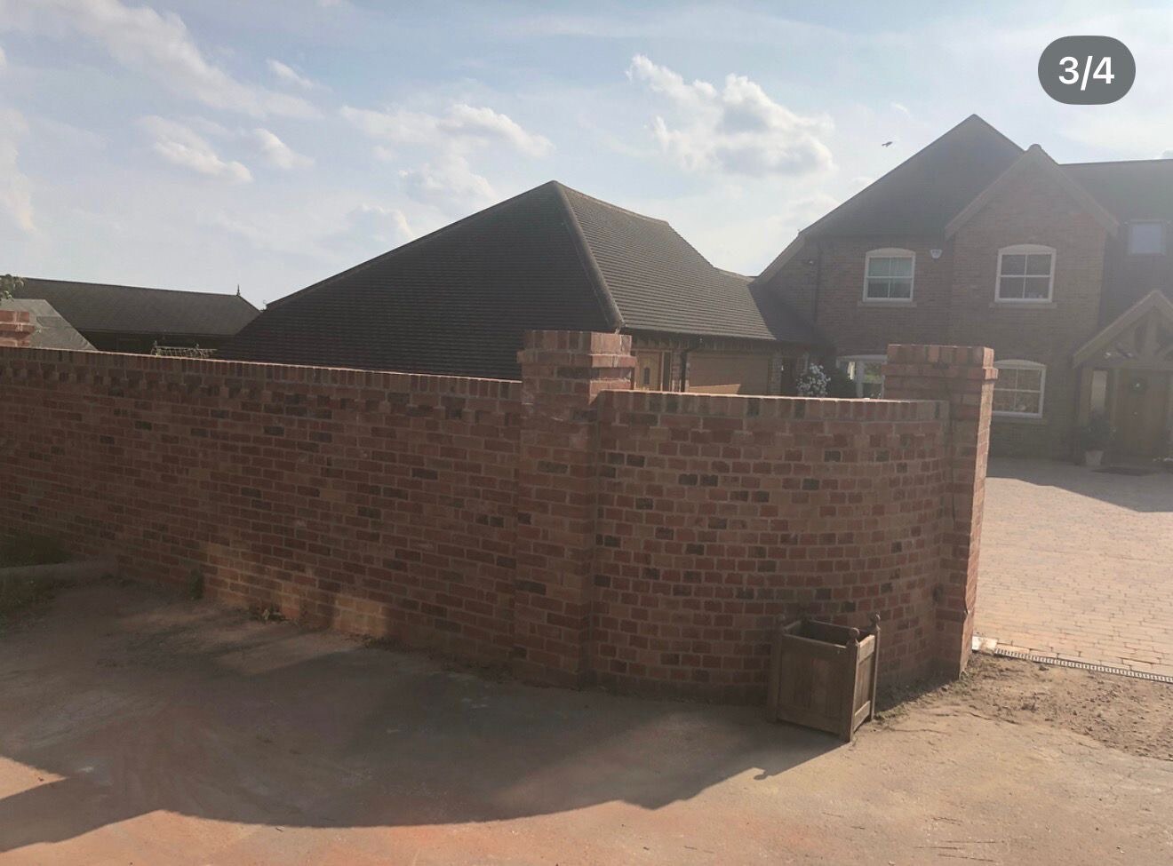 Completed reclaimed brick boundary wall with curved return and brick on edge coping