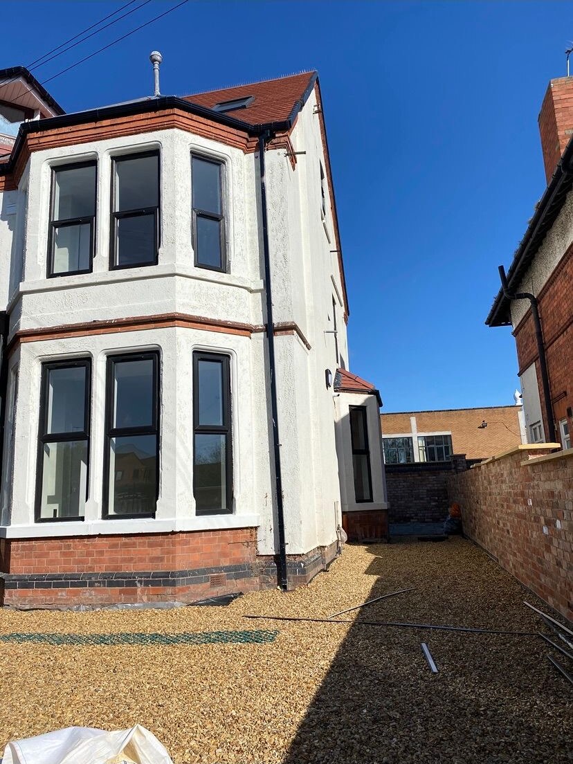 Renovated bay fronted townhouse with rendered elevation and new brick boundary wall
