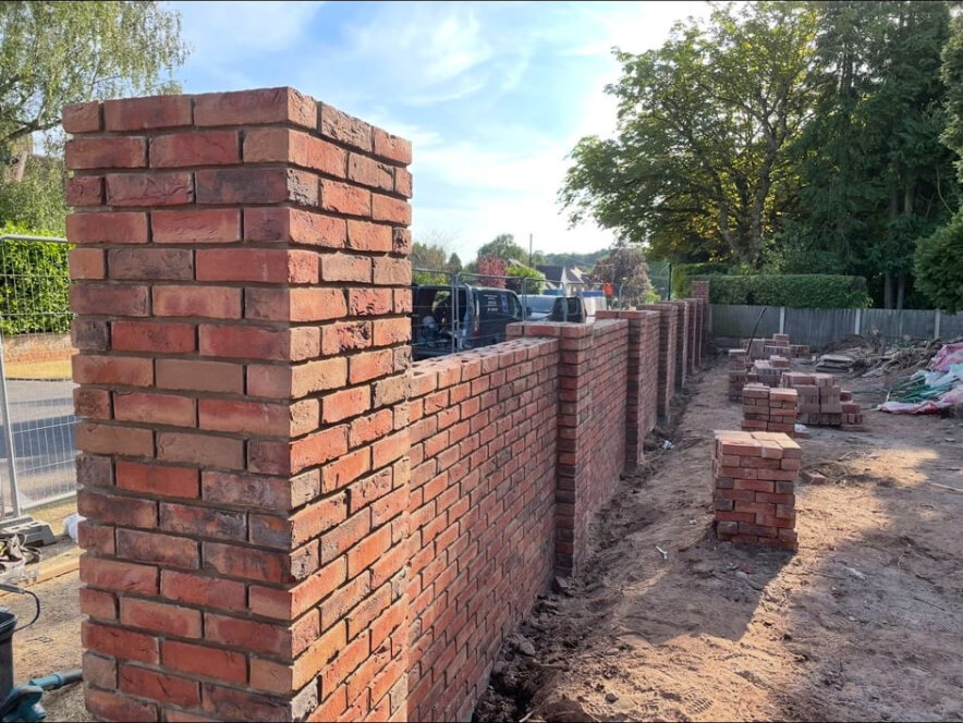 Reclaimed brick boundary wall and pier under construction in Bramcote, Nottingham
