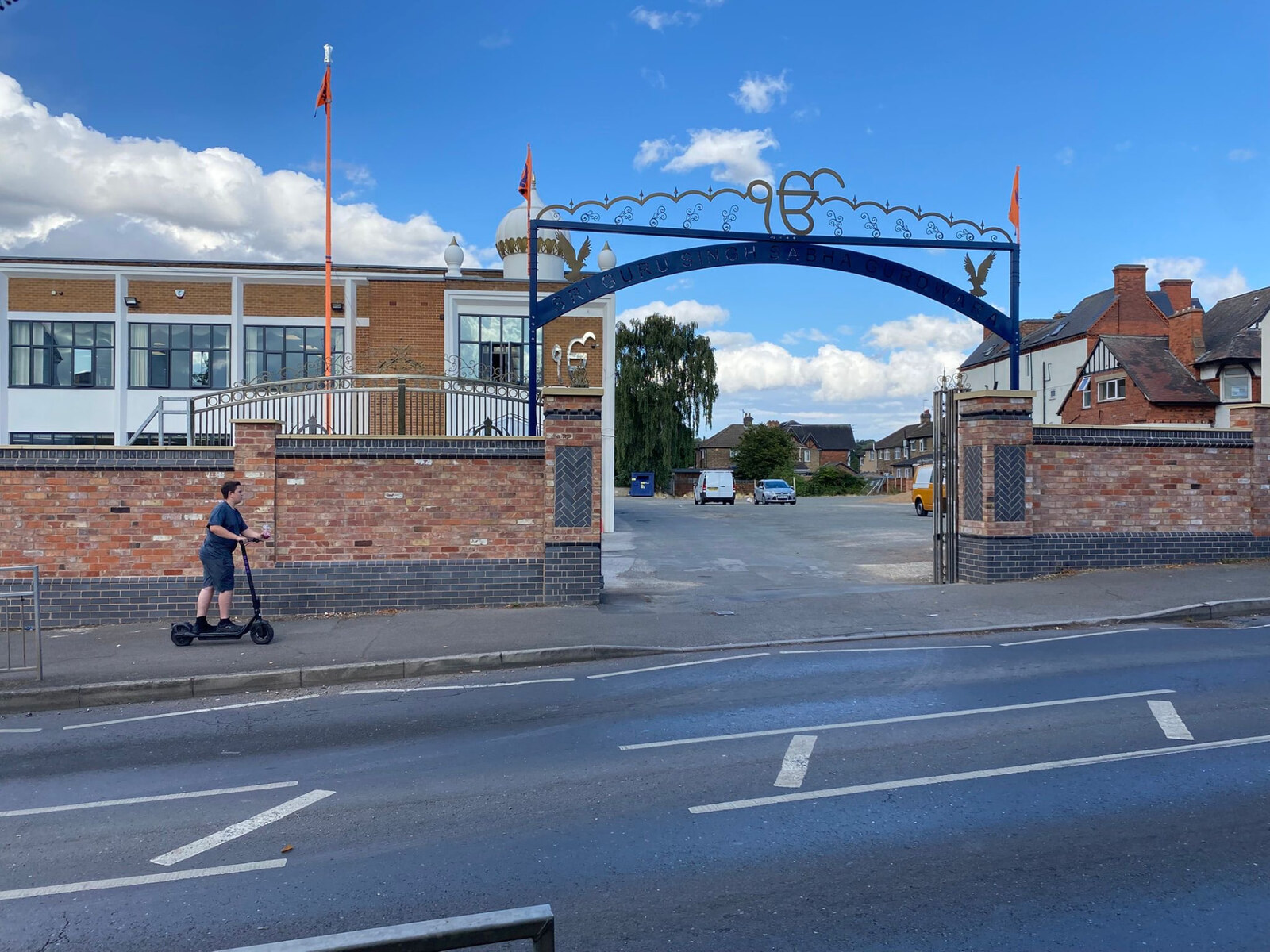 Completed reclaimed brick entrance boundary walls with blue brick plinths and decorative gateway