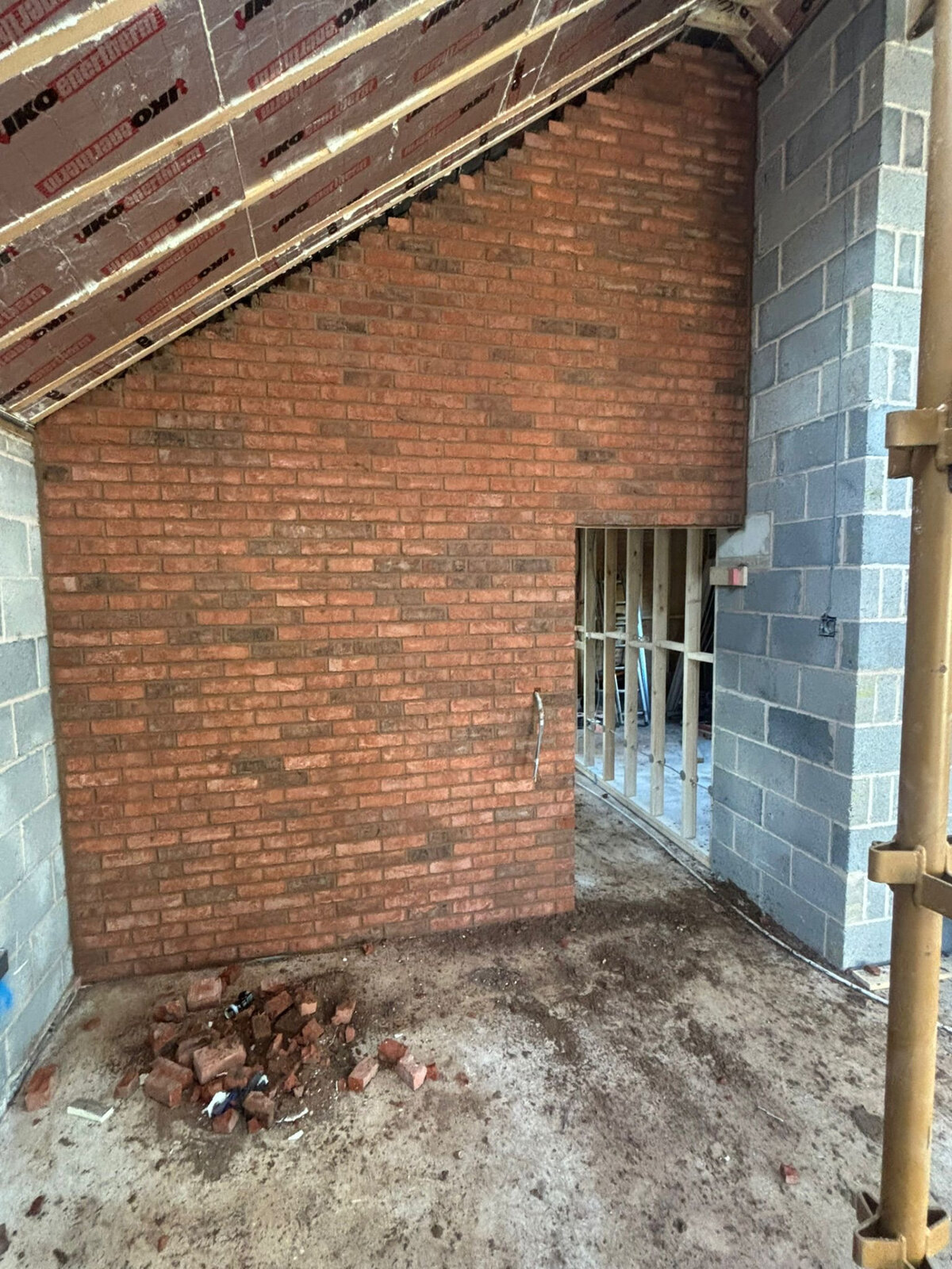Internal feature brick gable wall built in reclaimed style brickwork inside a new build property