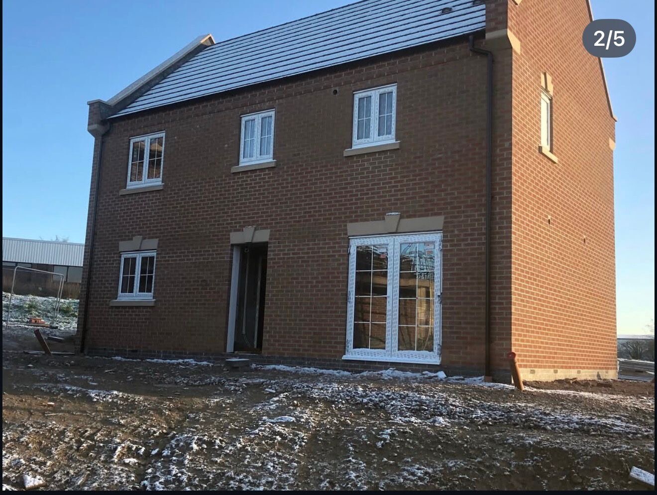 Newly completed red brick detached new build house on a winter morning